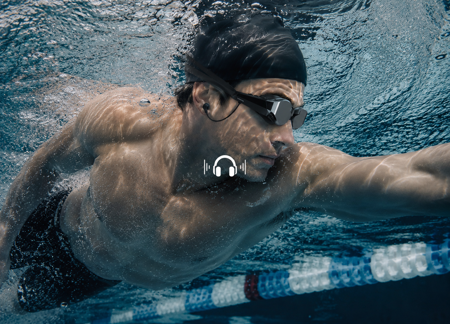 Swimmer wearing smart goggles and in-ear headphones during an underwater pool workout
