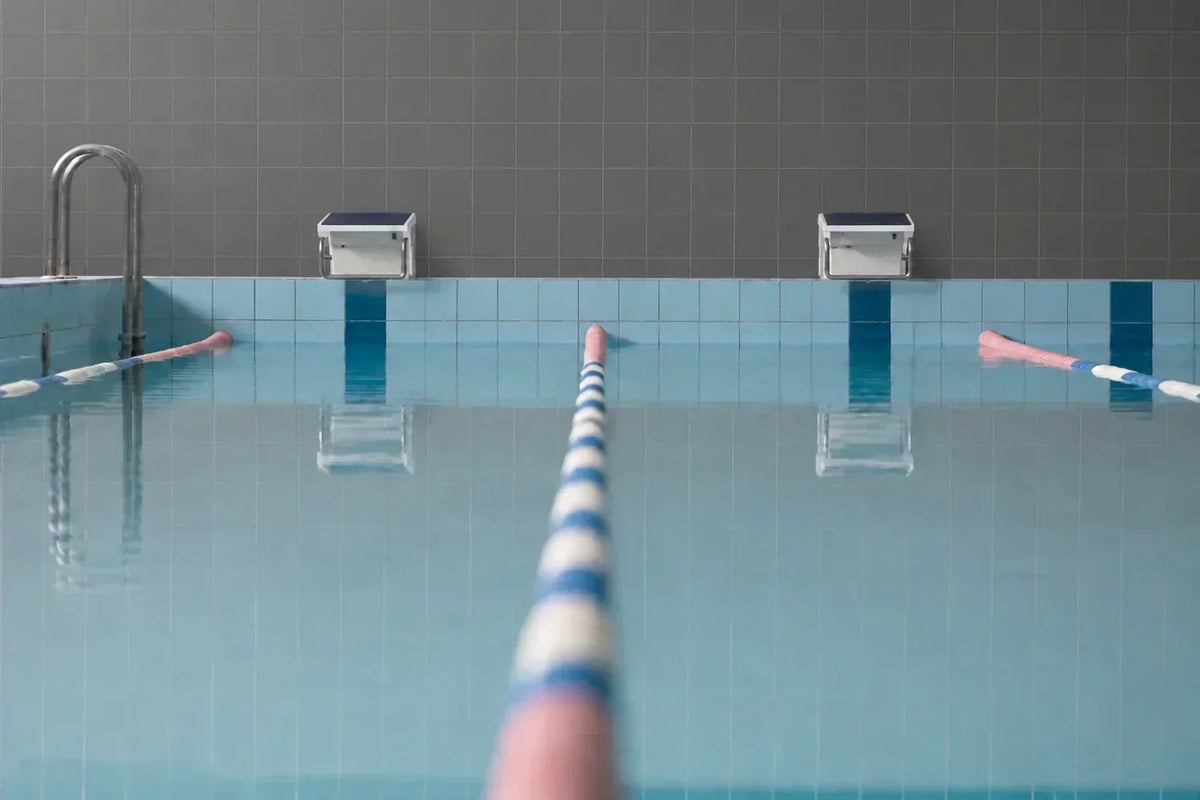 Empty indoor lap pool with starting blocks