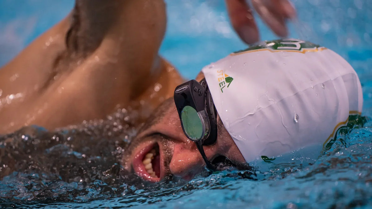 Swimmer wearing HoloSwim 2 Pro during a structured pool workout