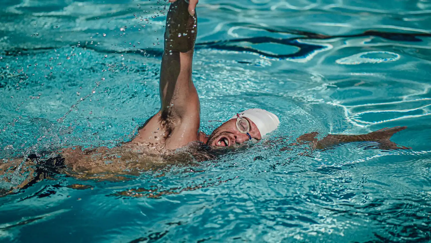 Freestyle swimmer holding a steady pace during a pool workout