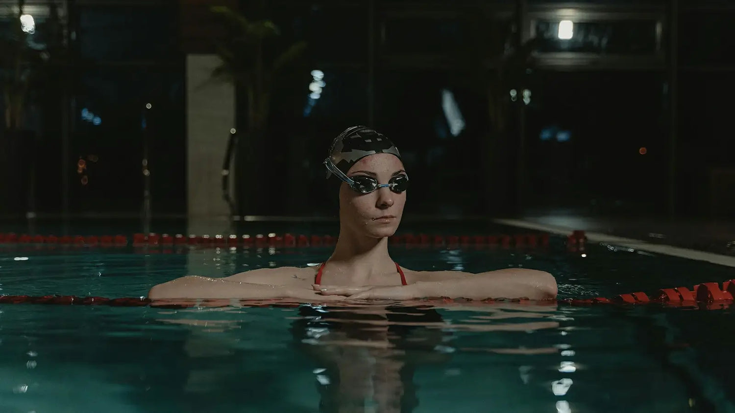 Nearsighted swimmer wearing prescription swim goggles at an indoor pool