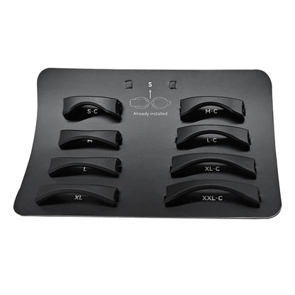 A black tray displaying seven curved Holoswim Nose Bridge pieces in black plastic, labeled S-C, M-C, L-C, L, XL-C, XXL-C, plus one marked "Already installed," with a small glasses diagram between them.