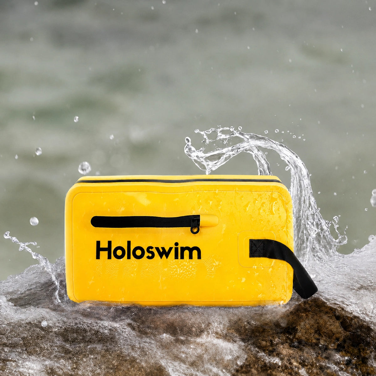 Yellow HoloSwim waterproof swimming bag on wet rocks